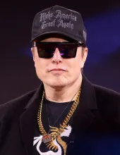 Elon Musk, who announced on X that Grok Bot can now make phone calls on a user's behalf, photographed at an event in National Harbor, Maryland.