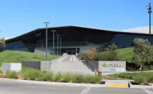A photograph of the NVIDIA headquarters building in Santa Clara, with its company sign in the foreground.